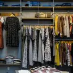Retail store with clothing items on shelves and hangers